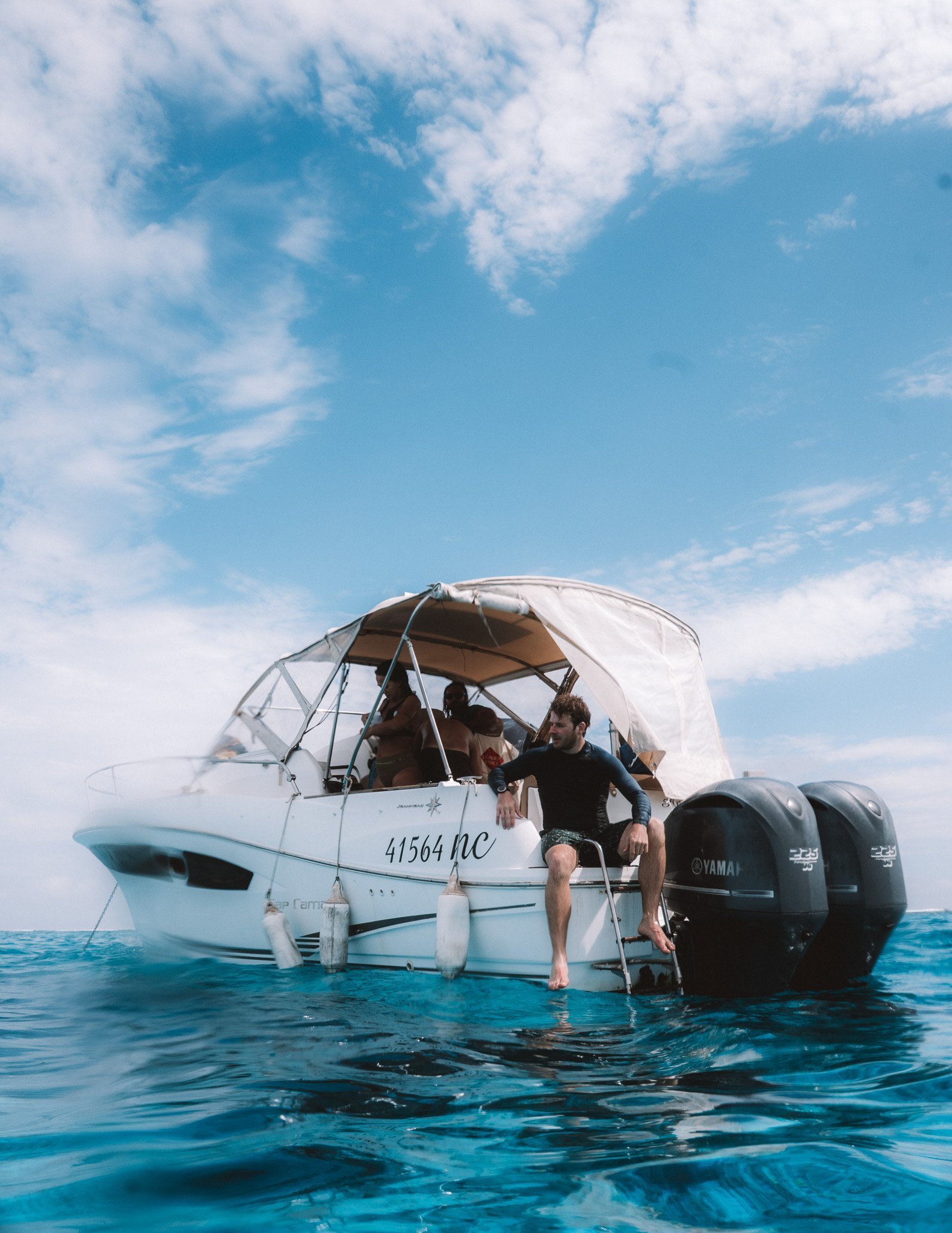 Herr Krank stepping off the boat into the lagoon